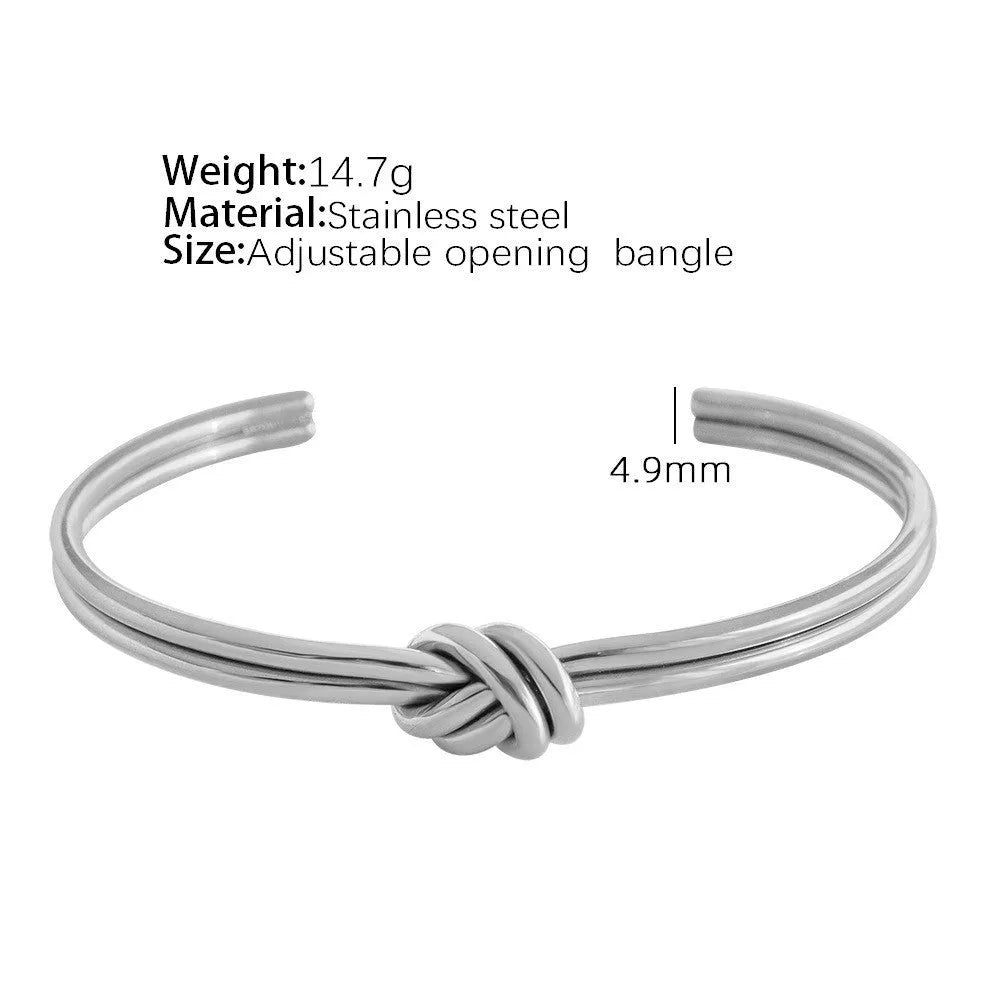 Women's knotted C-shaped open double-layer stainless steel bracelet with gold plating.