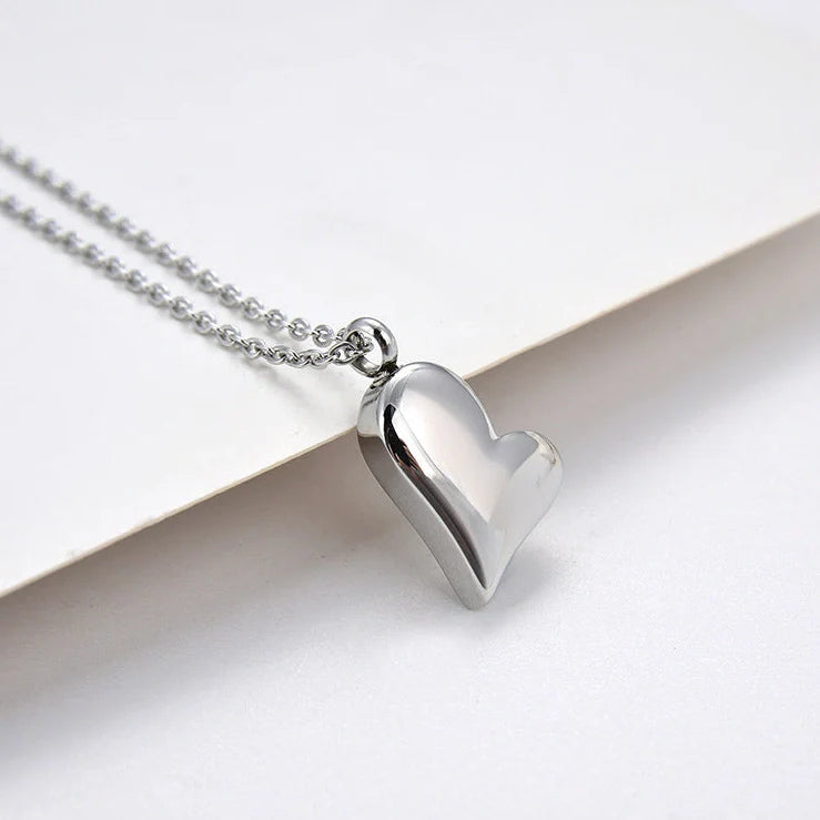 Silver curved peach heart pendant on stainless steel chain with adjustable length