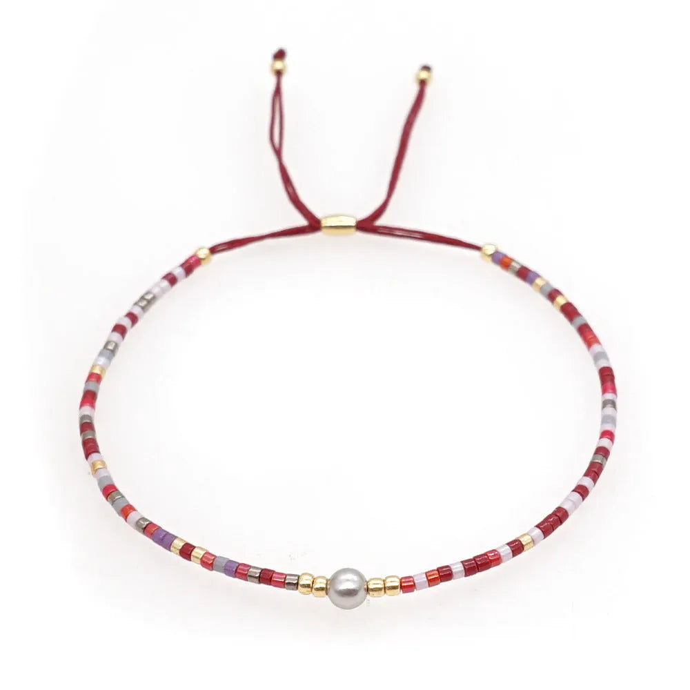 Handmade women's bracelet with colourful geometric glass and coloured glaze beads in Bohemian style.