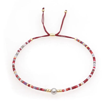Handmade women's bracelet with colourful geometric glass and coloured glaze beads in Bohemian style.