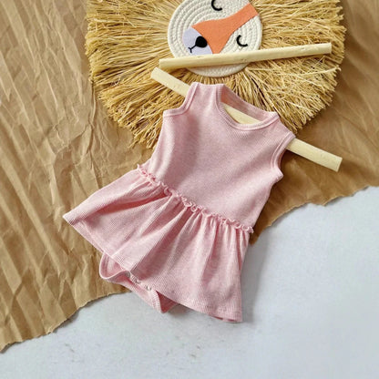 Baby girl wearing pink sleeveless vest onesie with waffle cotton texture and single-breasted closure