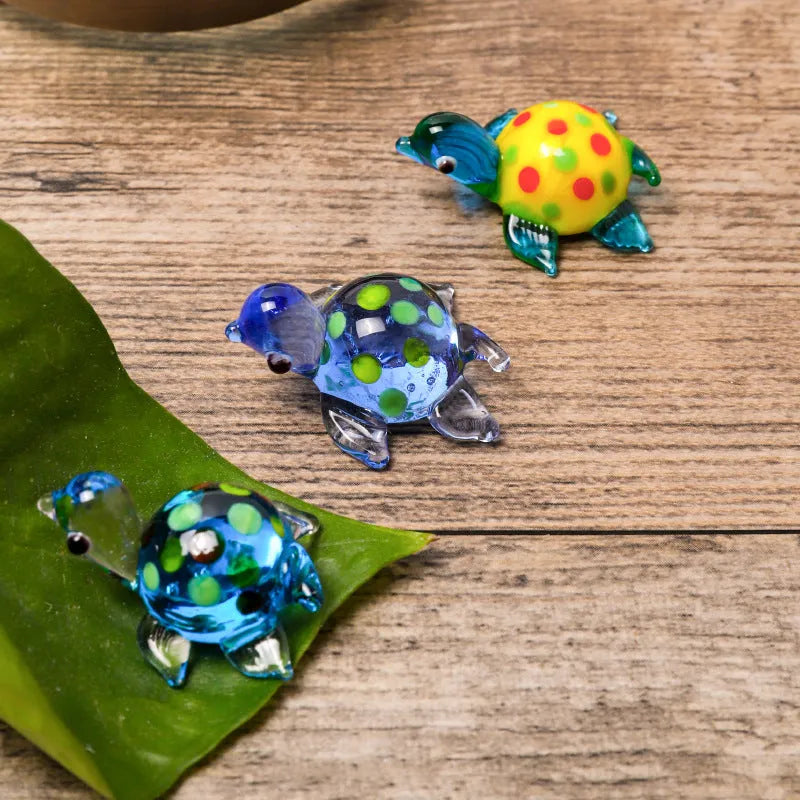 Geometric glass turtle figurine ornament on a desk, shown in blue head and blue shell colour variant.