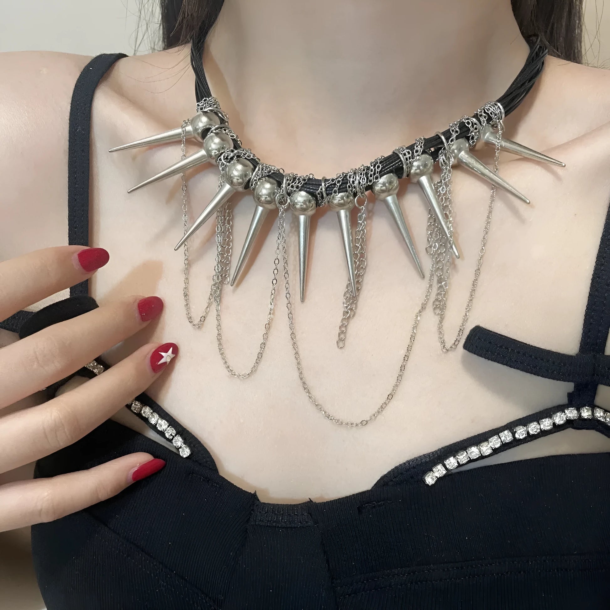 Women's leather necklace with electroplated rivet accents and round beads in winding tassel design