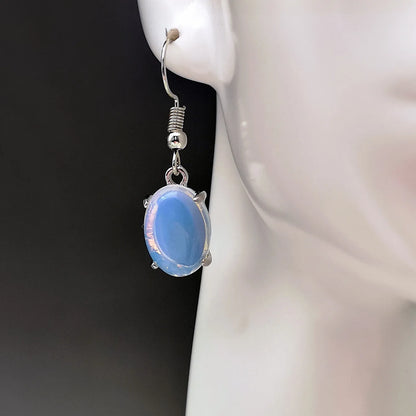 Opal earrings with electroplated alloy construction in moonlight white colour featuring drop shape design with ellipse elements and cross motif