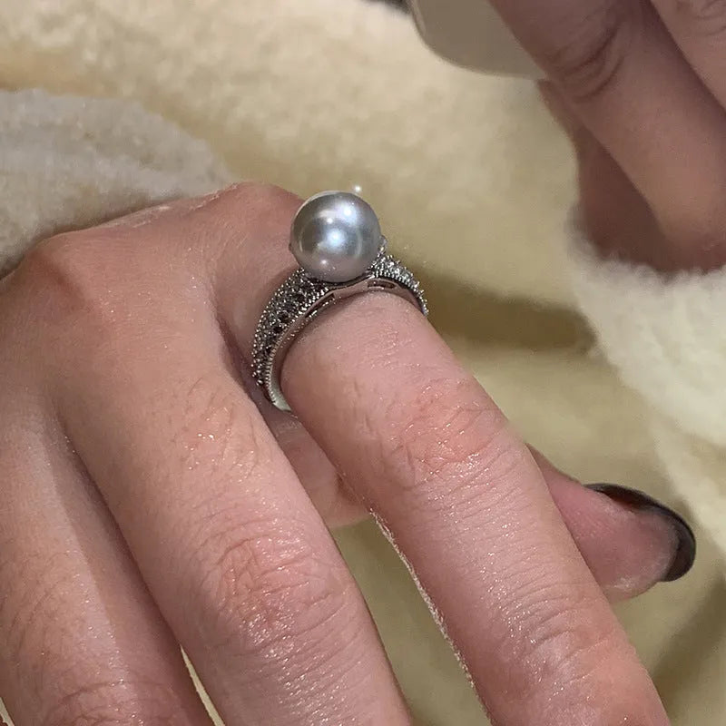 Black Pearl geometric open-ended adjustable copper ring on a woman's finger, showing angular design.