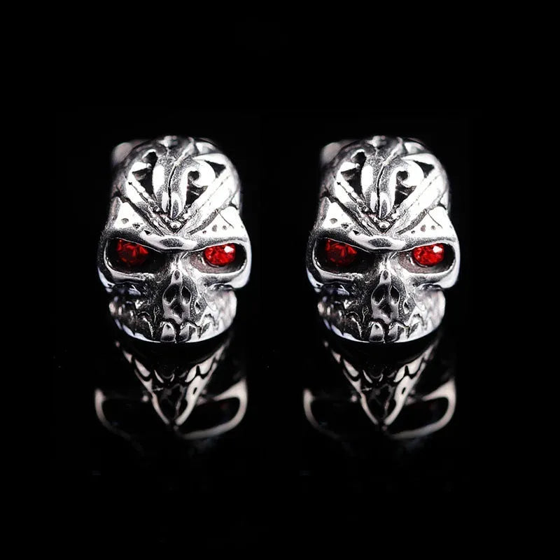 Red eye skull stud earrings with electroplated alloy construction and gemstone accents