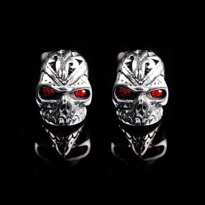 Red eye skull stud earrings with electroplated alloy construction and gemstone accents