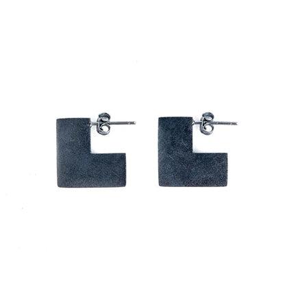 Oxidised black sterling silver earrings with a geometric square shape and minimalist ring design.