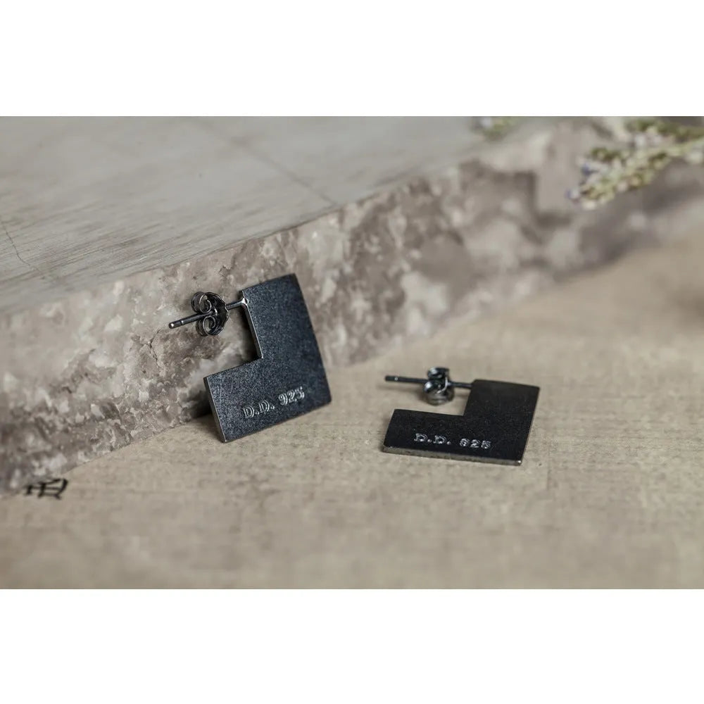 Oxidised black sterling silver earrings with a geometric square shape and minimalist ring design.
