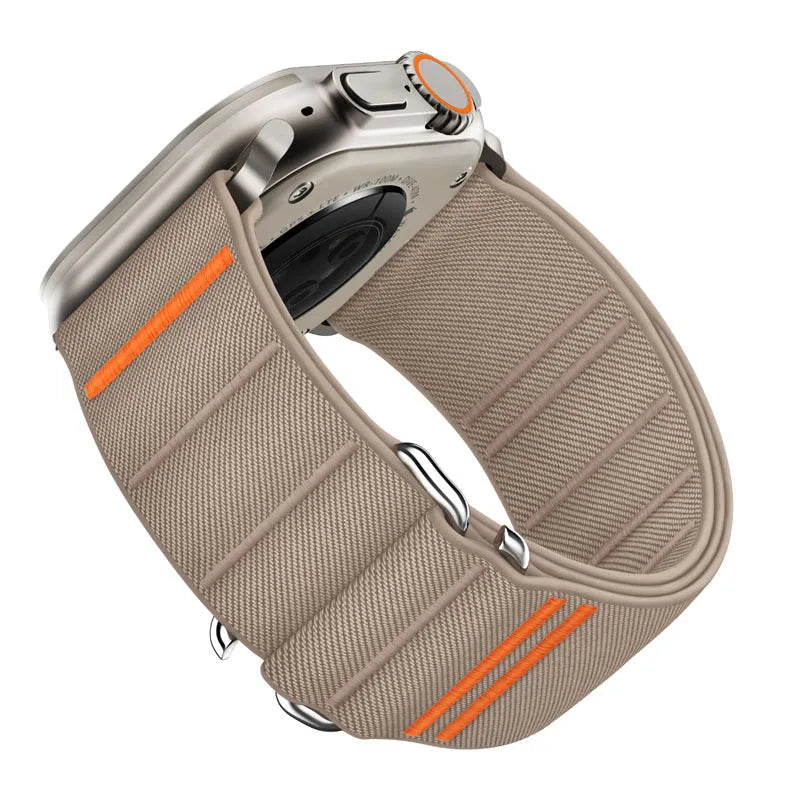 Elastic nylon Apple Watch band in Army Green with stainless steel buckle, shown on a wrist.