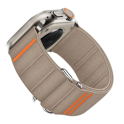 Elastic nylon Apple Watch band in Army Green with stainless steel buckle, shown on a wrist.