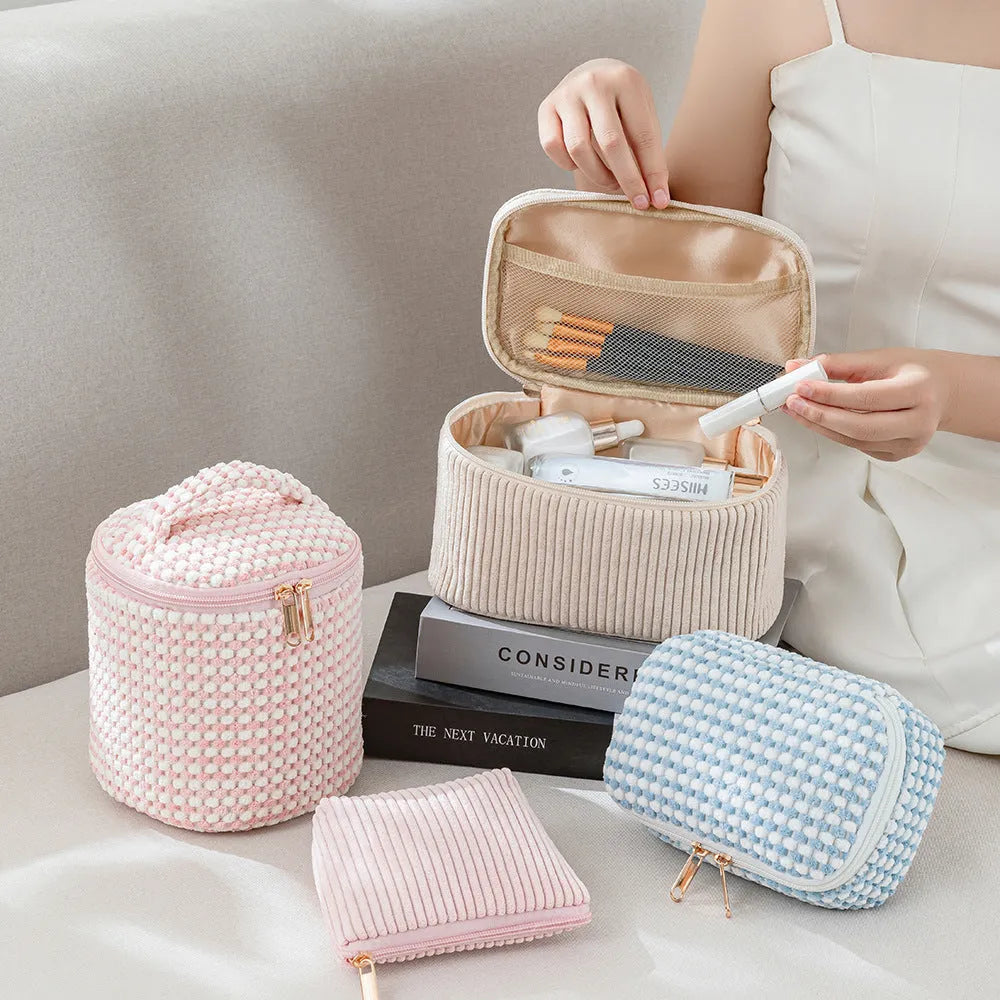 Four cube-style flannelette makeup bags in pink, khaki, pink dots, and blue with dots colours showing compartment organisation