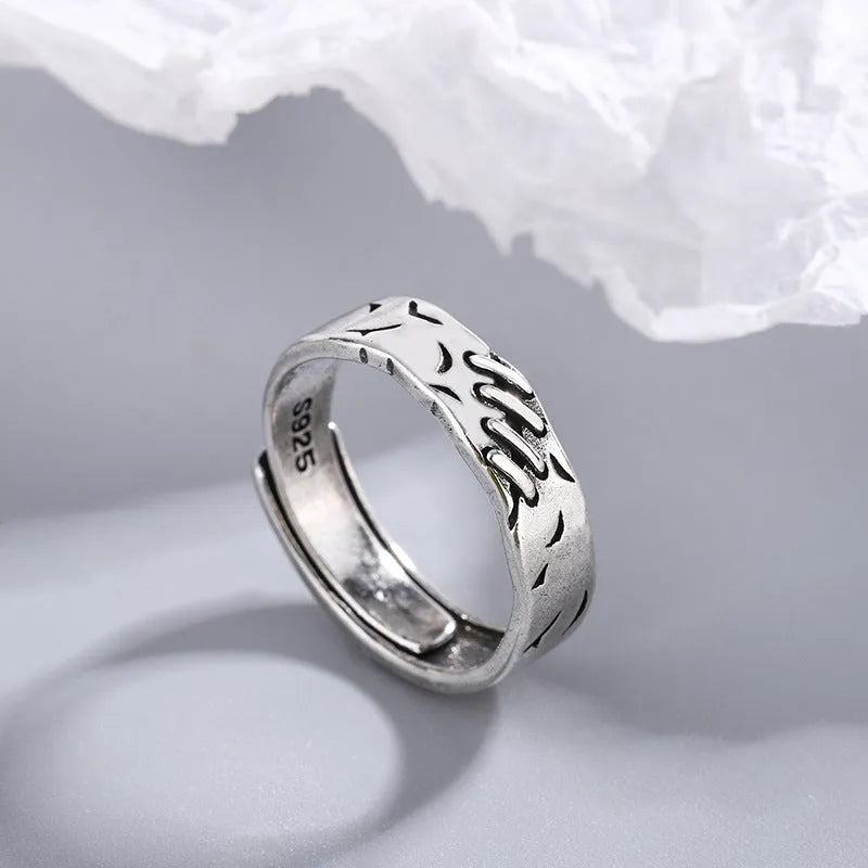 Black copper geometric ring with adjustable opening and round oval design elements