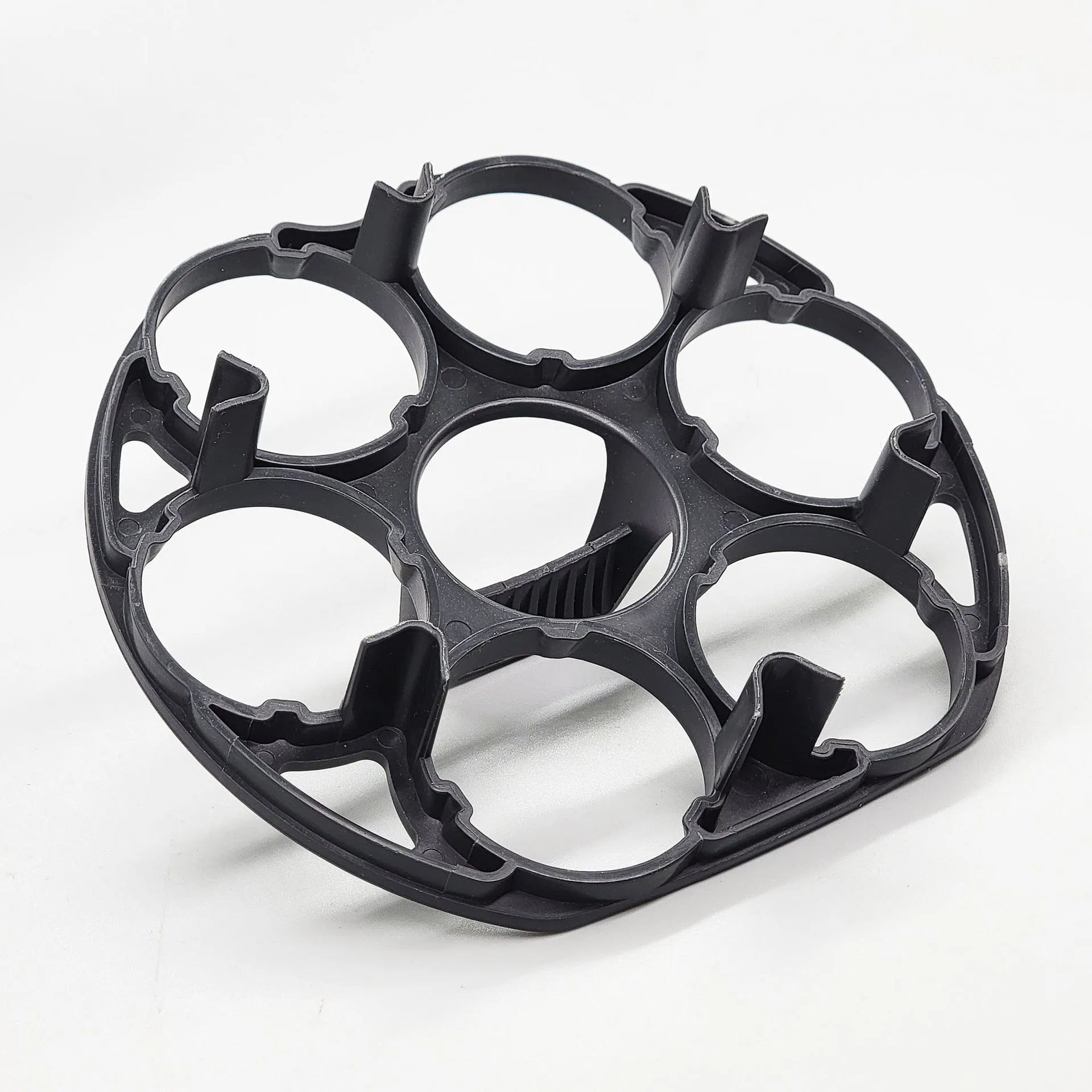 Black plastic egg holder rack for a cooking machine, shown from above.