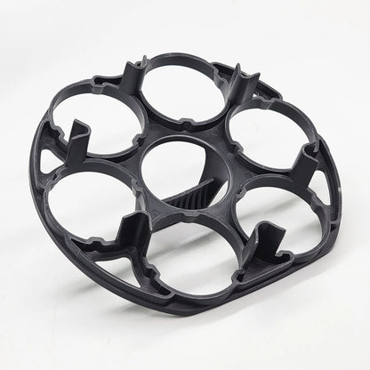 Black plastic egg holder rack for a cooking machine, shown from above.