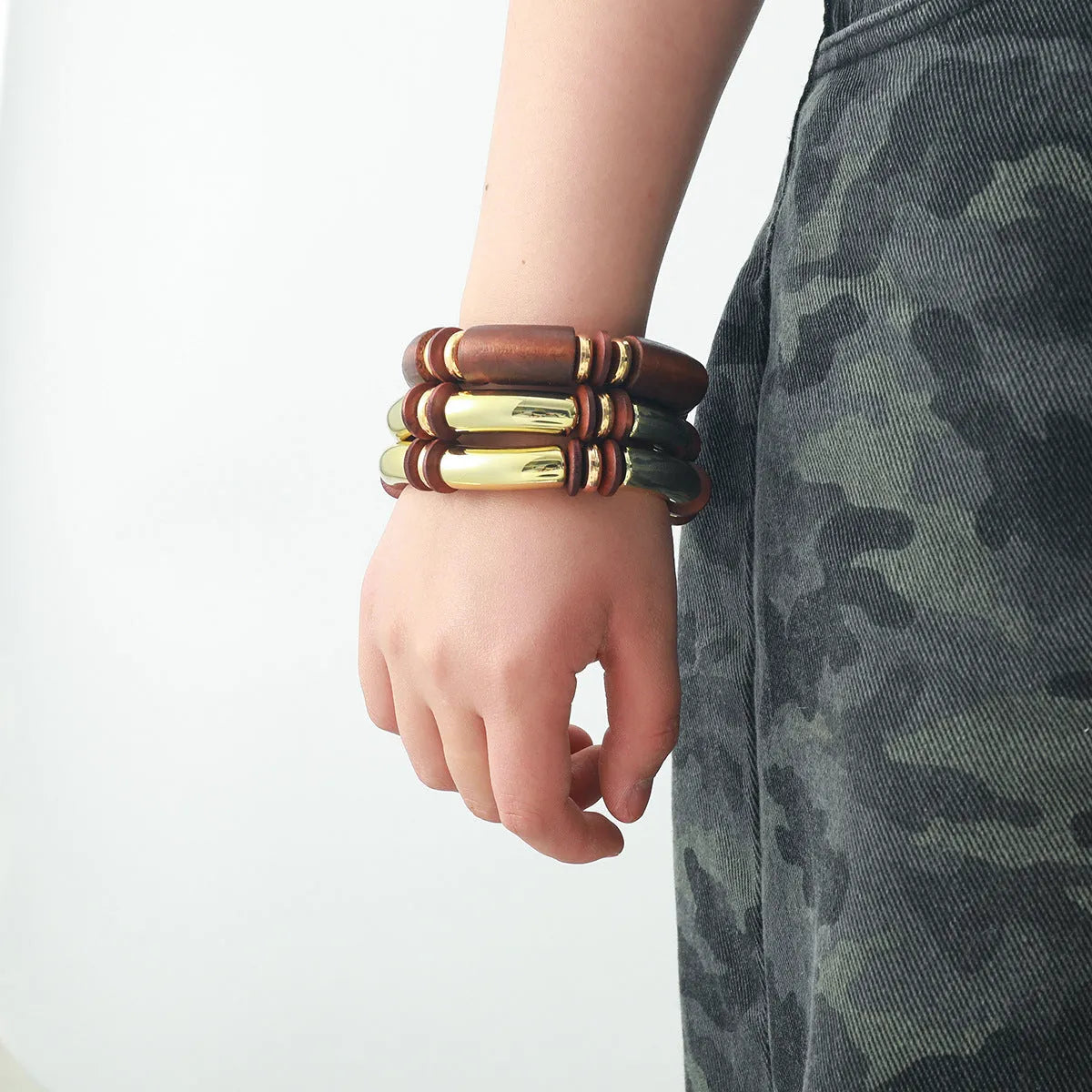 Women's exaggerated multi-layer wooden bead necklace and matching alloy bracelet set on a white background