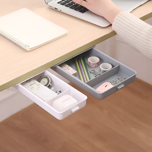 White plastic storage box with grid compartments and adhesive backing for under-table mounting
