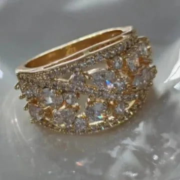 Women's round hollow copper ring showing gold and platinum plating options with sapphire blue and white accents