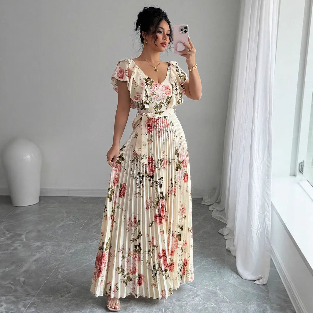 Apricot-coloured V-neck dress with floral print, ruffled short sleeves, high waist, and a long, pleated swing skirt.