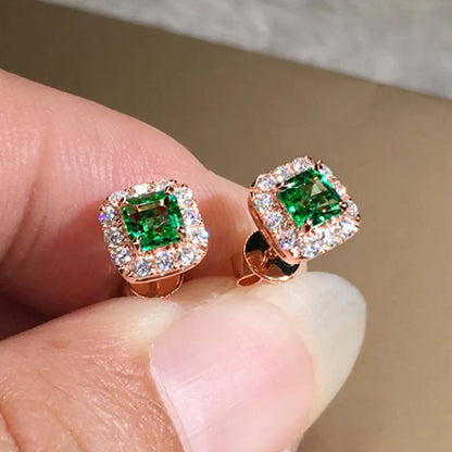 A pair of bright green square zircon stud earrings with a gold electroplated setting on a white background.