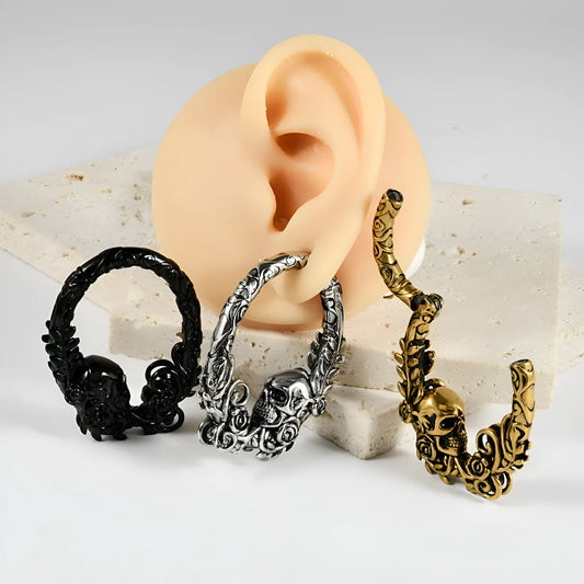 A pair of stainless steel fashion earrings featuring a totem pattern design in an electroplated colour.