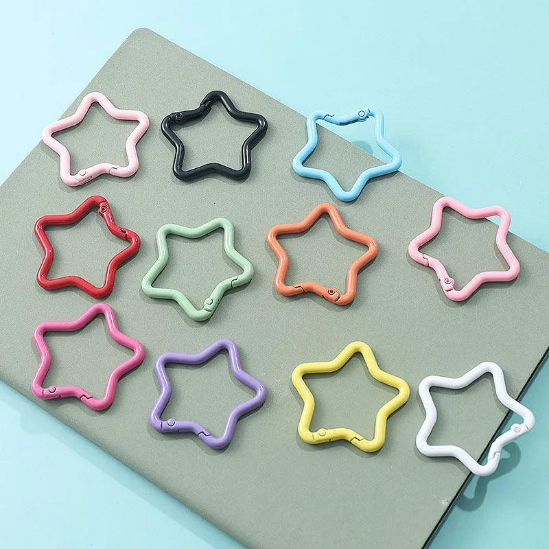 Zinc alloy five-pointed star keychain backpack hanging accessory in a macaron colour palette includes black, blue, green, light pink, orange, peach pink, purple, red, white and yellow for DIY ornament customisation.