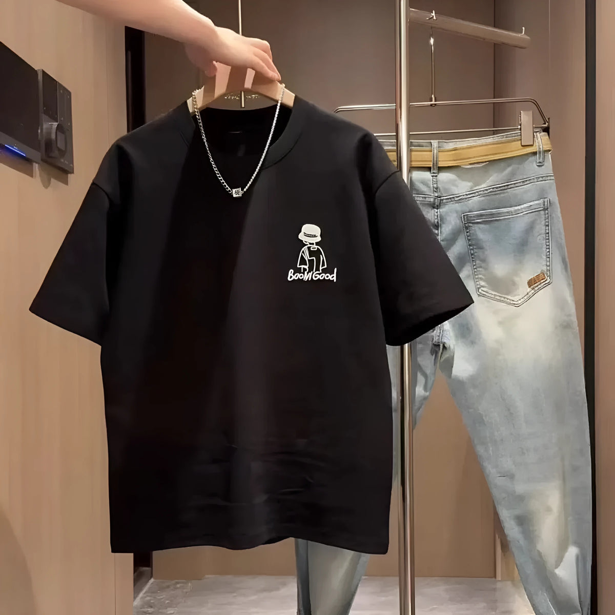 Men's black cotton t-shirt with a cartoon print, showing the slim fit and short sleeve design.