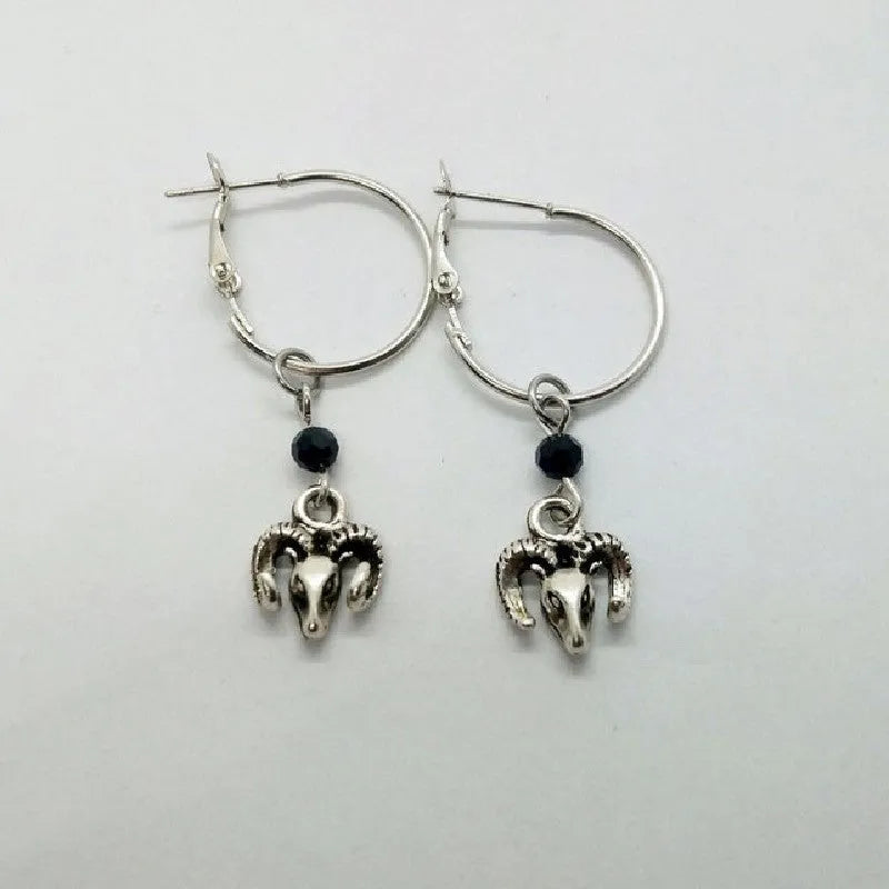 Silver round ring earrings with 2.5 cm diameter on display