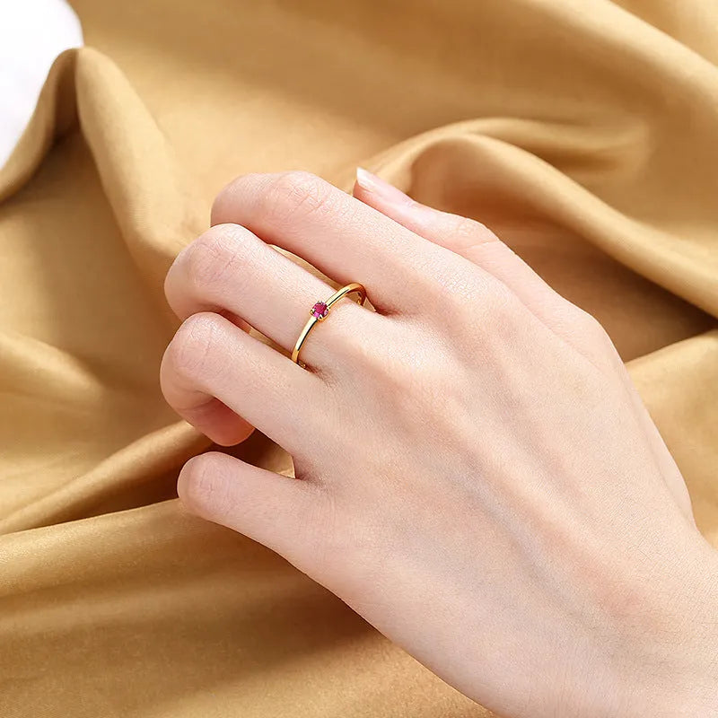 Twin Style copper geometric circle ring with a single diamond, shown in blue, green, red, or white.