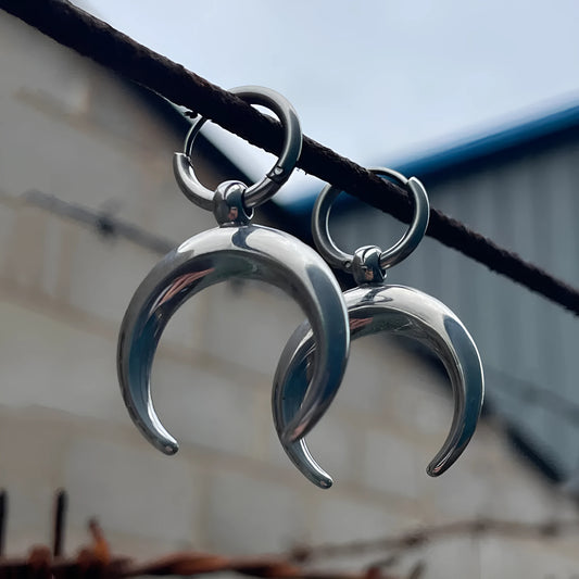 Silver big hoop earrings with a gothic moon and geometric punk design, ear clip style.
