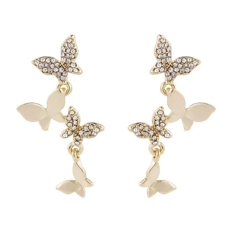 A pair of gold-coloured copper drop earrings with four detailed butterfly charms.