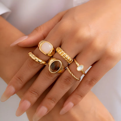 Six irregular geometric alloy rings with light gold electroplated finish arranged as a jewellery set