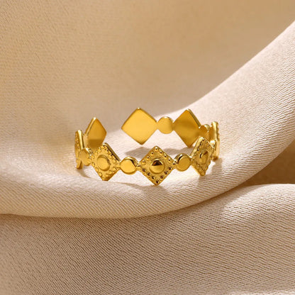 Gold tone geometric titanium steel women's ring with a small diamond accent on an adjustable band.