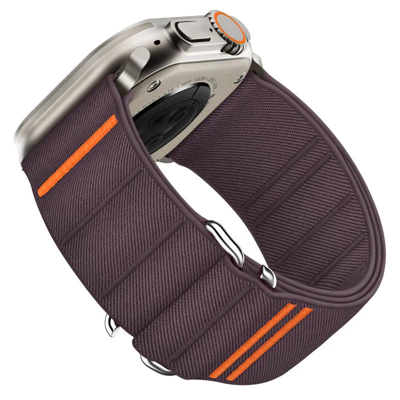 Elastic nylon Apple Watch band in Army Green with stainless steel buckle, shown on a wrist.