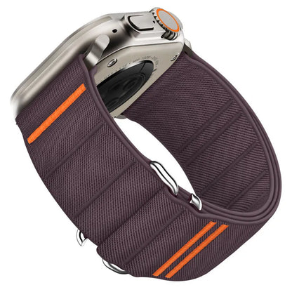 Elastic nylon Apple Watch band in Army Green with stainless steel buckle, shown on a wrist.