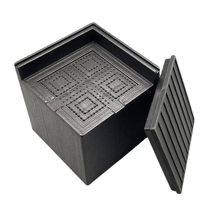 Set of four round black plastic furniture risers, each 3cm tall, on a wooden floor.