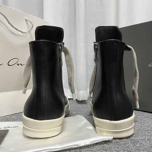 Black high-top leather sneakers with side zipper, round toe, and stitching details on genuine cowhide upper