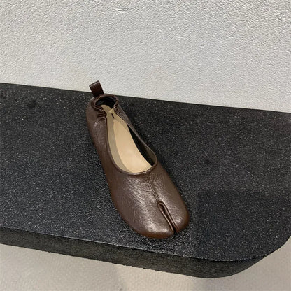 Women's black split-toe chunky heel pumps with round toe and low heel on a white background