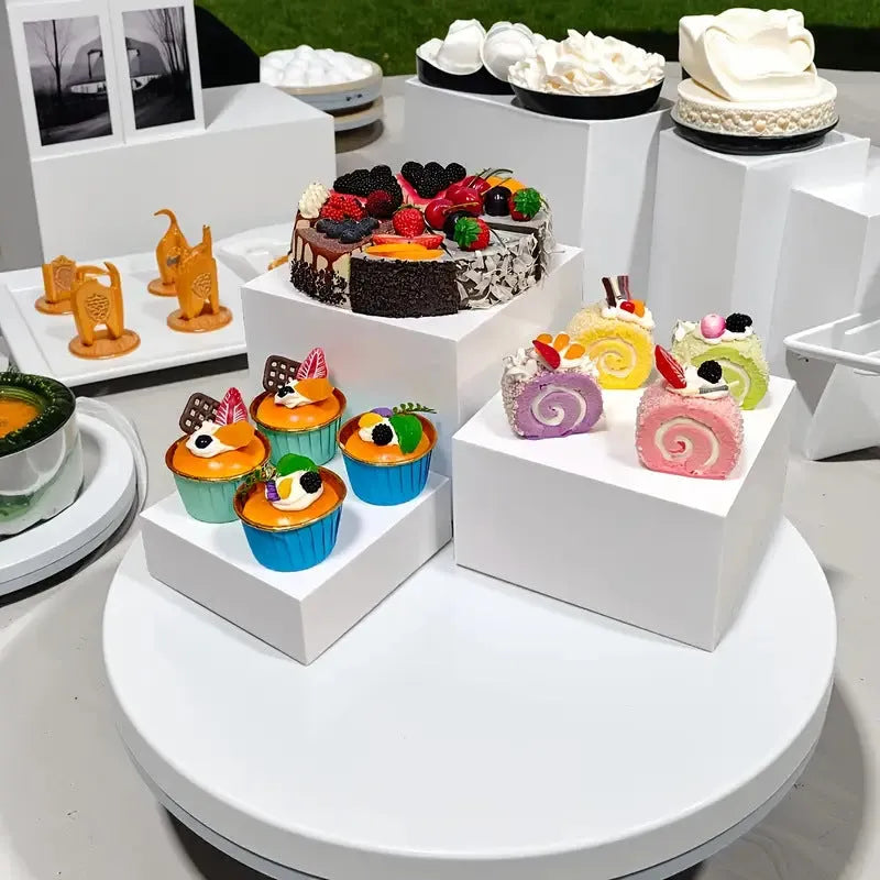 Six acrylic cubes in graduated sizes 3-8cm for dessert display, available in transparent or white