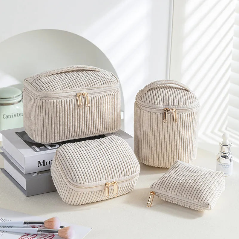 Four cube-style flannelette makeup bags in pink, khaki, pink dots, and blue with dots colours showing compartment organisation