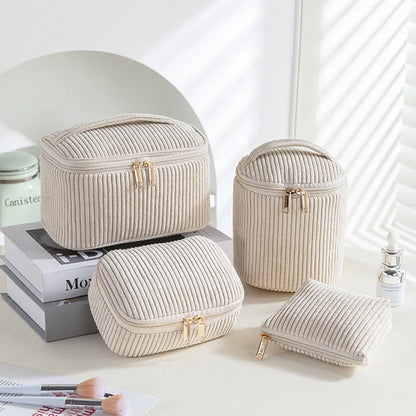 Four cube-style flannelette makeup bags in pink, khaki, pink dots, and blue with dots colours showing compartment organisation