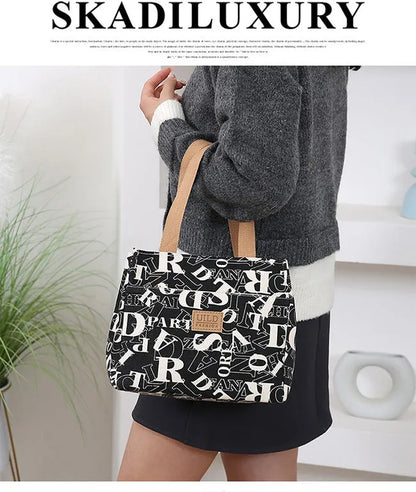 Women's portable printed canvas bag in horizontal square shape with floral design, showing reinforced base and large capacity.