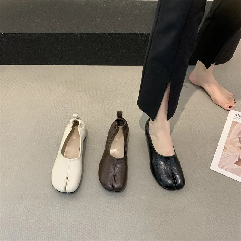 Women's black split-toe chunky heel pumps with round toe and low heel on a white background