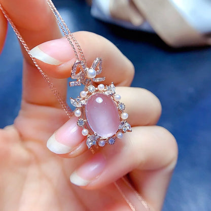 Geometric rose quartz pendant necklace on sterling silver chain with rose gold plating.