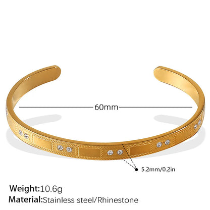 Stainless steel open-end bracelet with a buckle clasp in a gold electroplated finish featuring circle design elements.