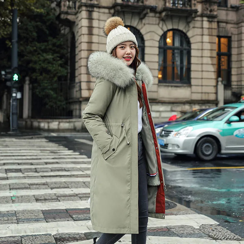 Long white women's fleece trench coat with down cotton padding on a hanger.