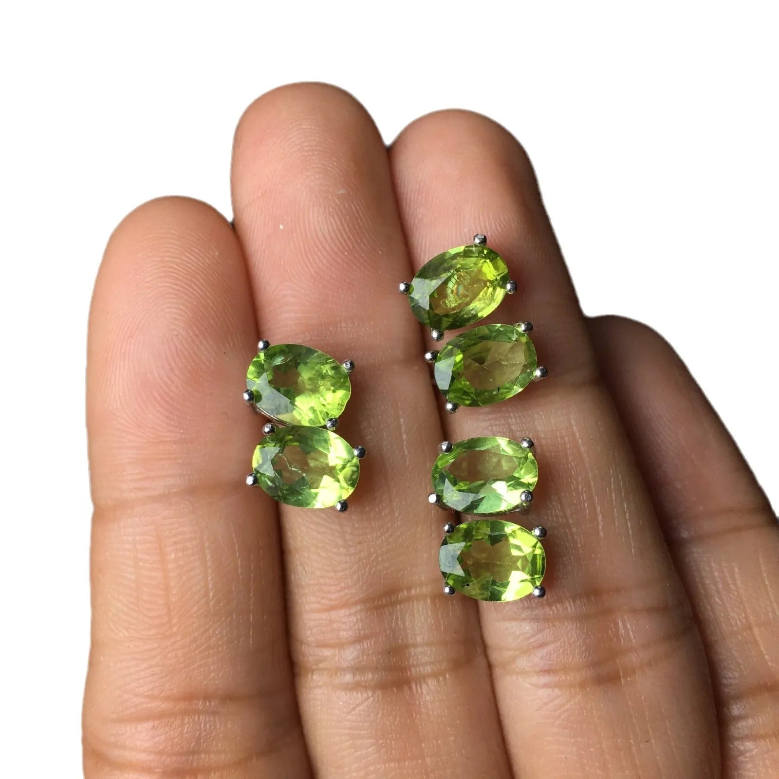 Close-up of grass green natural olivine stud earrings with geometric cut on S925 silver posts
