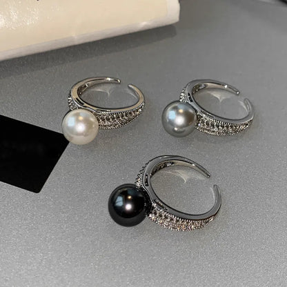 Black Pearl geometric open-ended adjustable copper ring on a woman's finger, showing angular design.