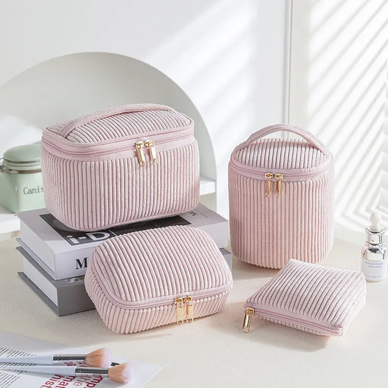 Four cube-style flannelette makeup bags in pink, khaki, pink dots, and blue with dots colours showing compartment organisation