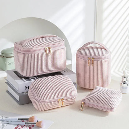 Four cube-style flannelette makeup bags in pink, khaki, pink dots, and blue with dots colours showing compartment organisation